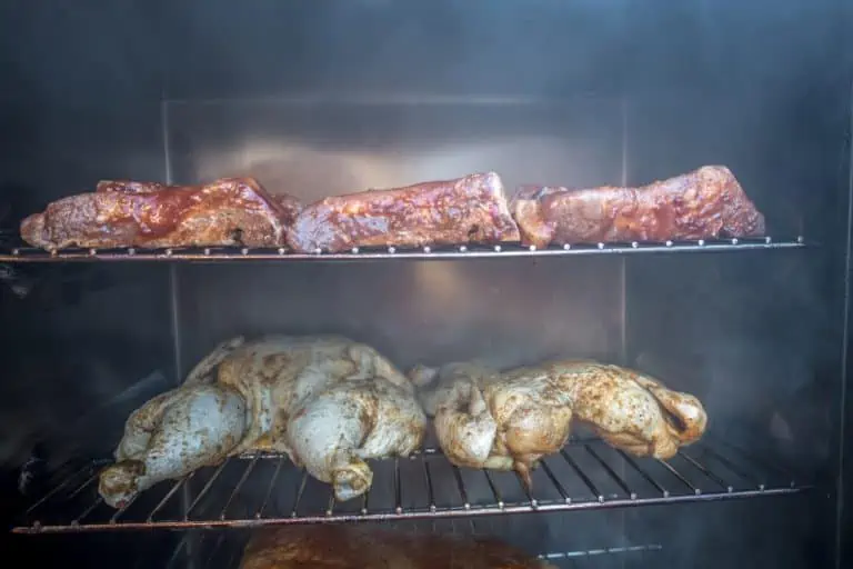 electric smoker loaded with variety of meat