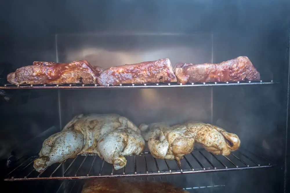 electric smoker loaded with variety of meat