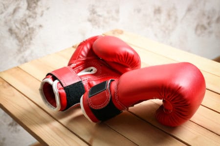 Boxing gloves on top of a wooden bench
