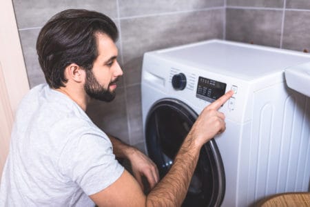 Man setting washing machine