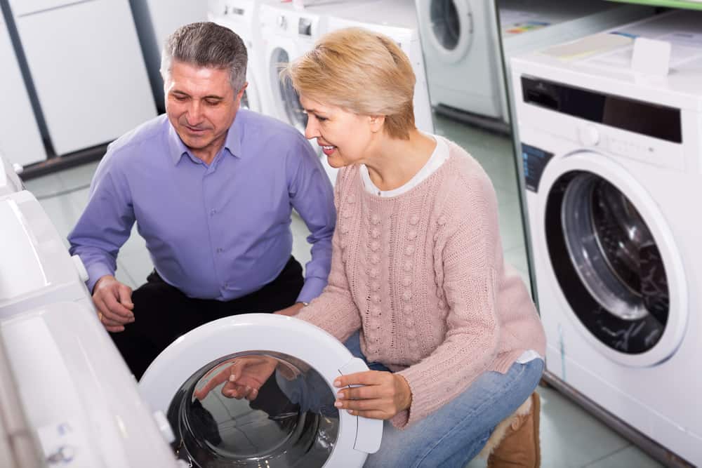 Mature couple choosing a washer