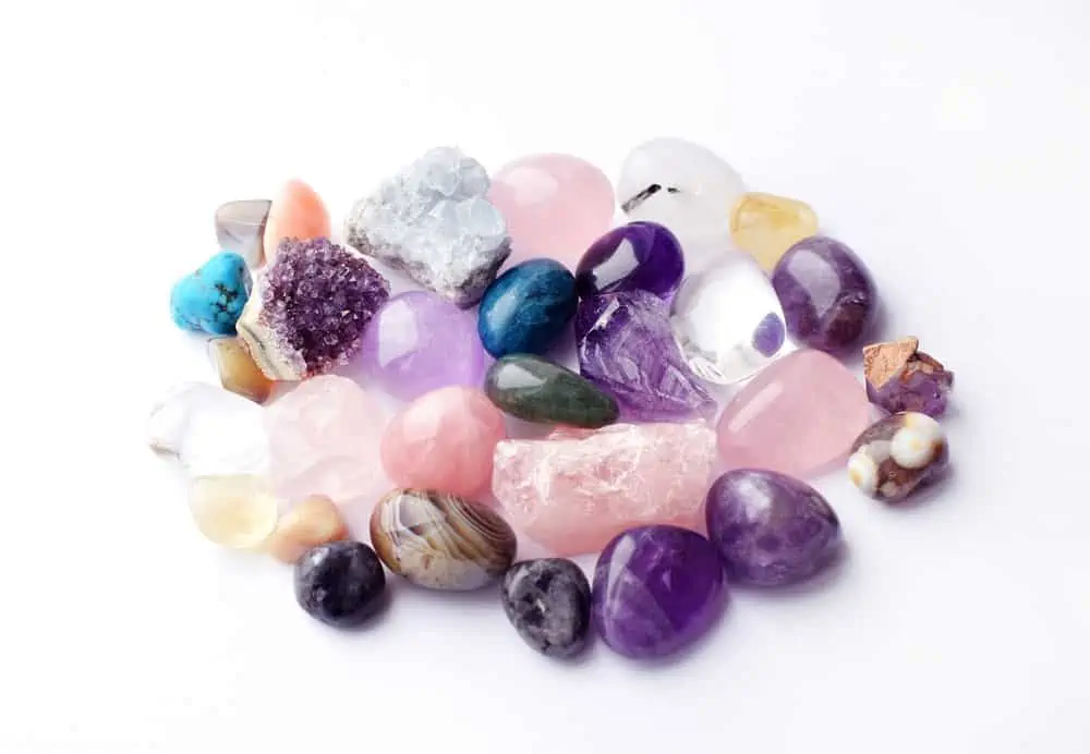 Gems of various colors - Geode amethyst, rose quartz, agate, apatite, aventurine, olivine, turquoise, aquamarine, rock crystal on white background