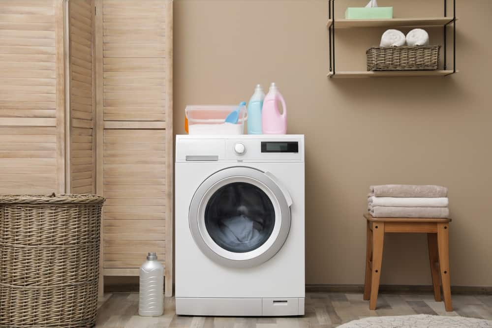 Modern front load washing machine in laundry room