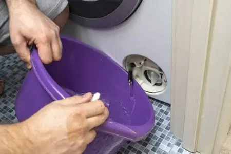 Man draining water from washing machine
