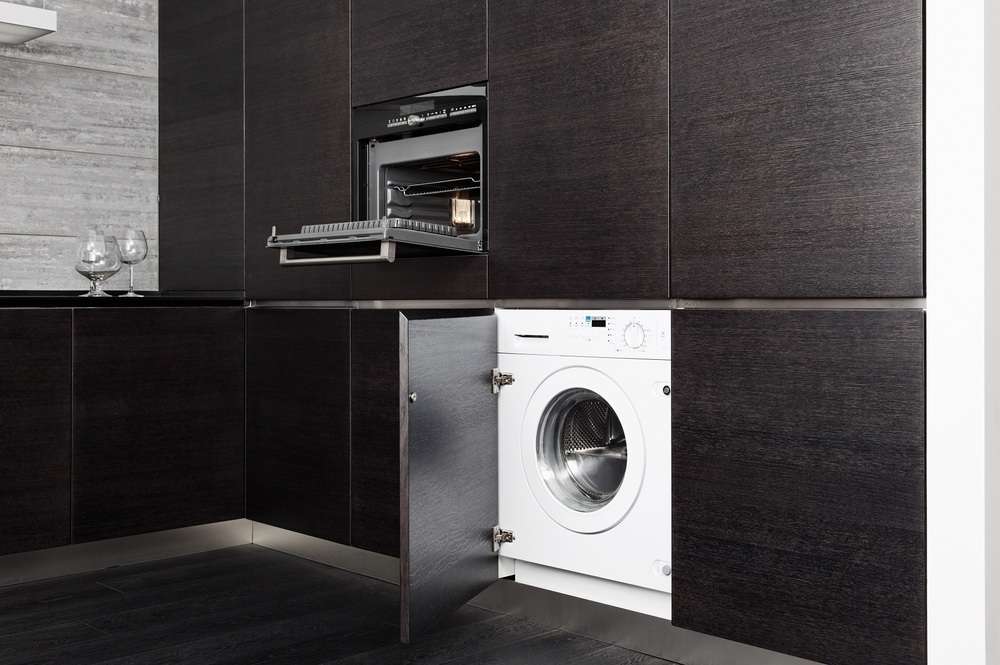 Built-in integrated washer in a black modern kitchen