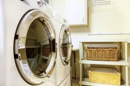 Whirlpool dryer in old style laundry room with baskets