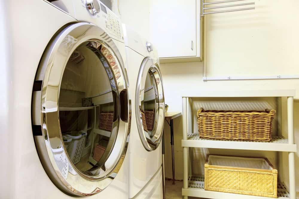 Whirlpool dryer in old style laundry room with baskets