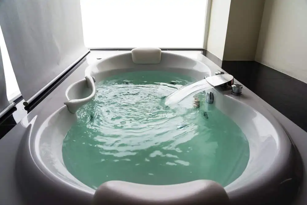 White jetted tub with turquoise water