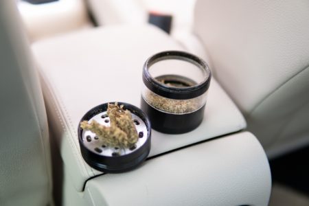 Grinder with cannabis inside of white car