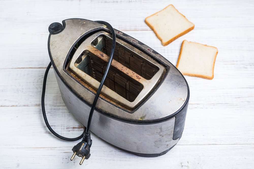 Dirty old toaster and two breads