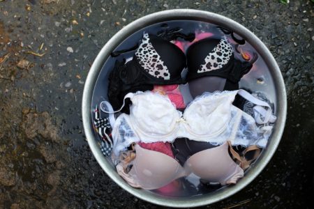 Bucket full of water with soaked bras