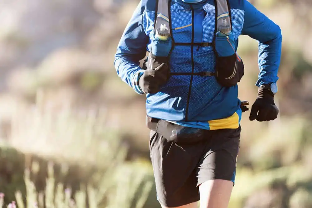 Male athlete running with hydration pack