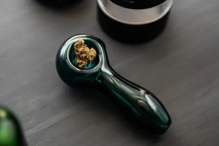 Smoking glass pipe with cannabis buds weed