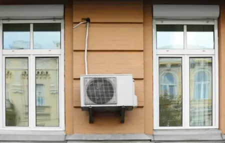 Air conditioner on wall of building outdoors