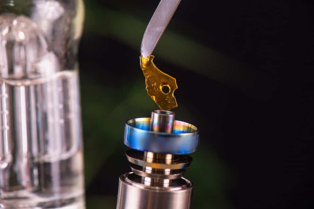Dabbing tool with small piece of cannabis oil