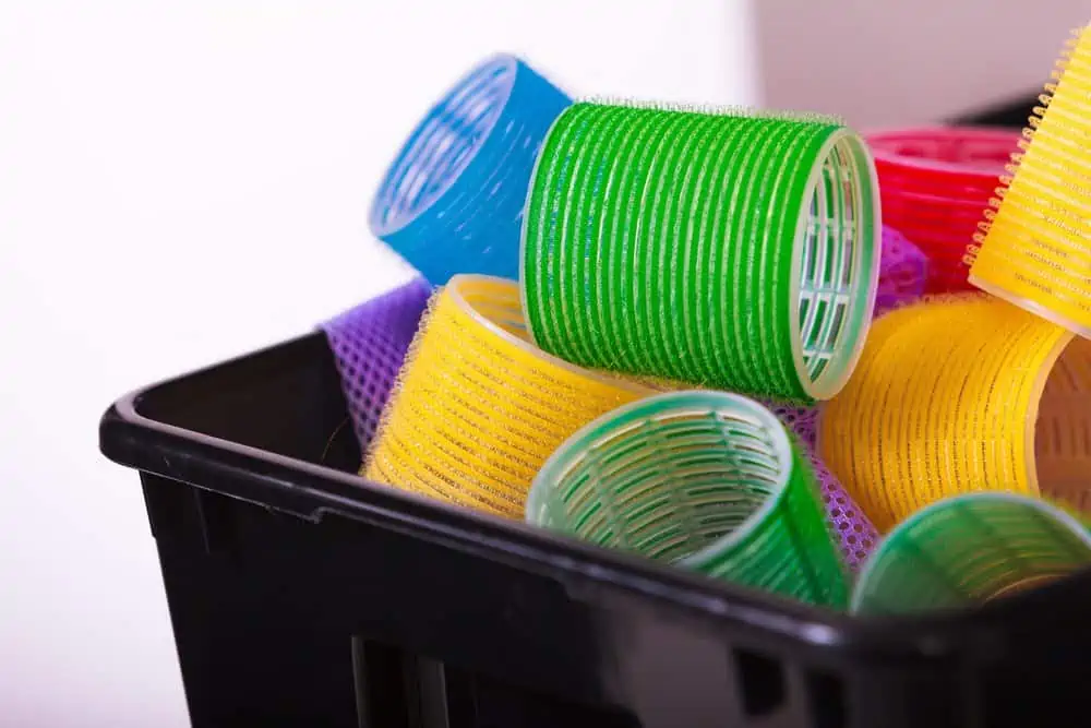 Colorful hair rollers curlers in black basket