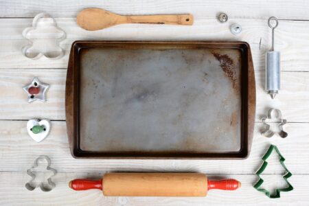 Overhead shot of old baking sheet with cookie molders
