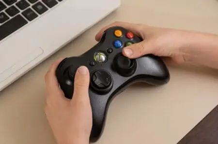 Male hand holding xbox one controller
