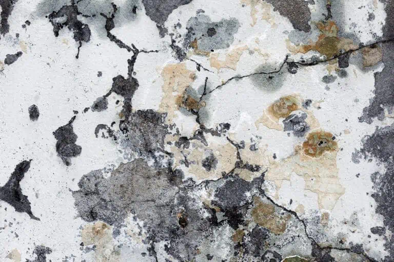Dirty concrete wall with streaks of stains