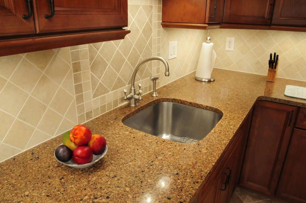 Stainless steel sink in the kitchen with quartz countertop