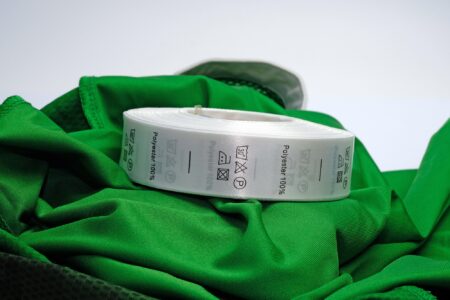 Green polyester fabric with satin ribbon tag
