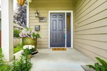 Clean porch with concrete floor decorated with flower pots