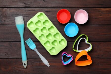 Set of silicone utensils on brown wooden table